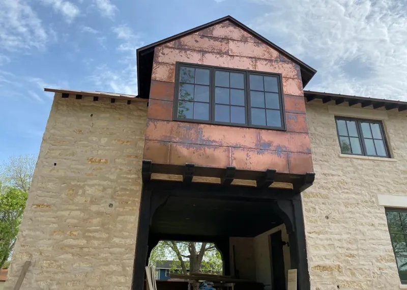 Copper metal panel facade on a stone building for Skylight Installation in San Benito